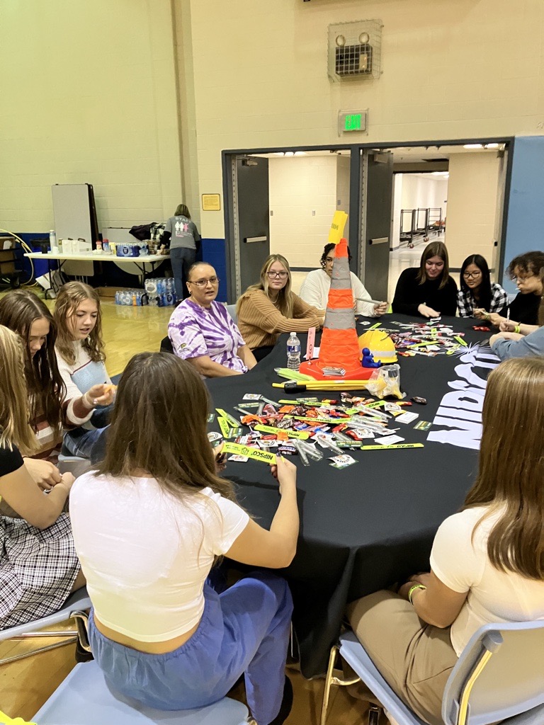 Students doing activity at Nipsco table