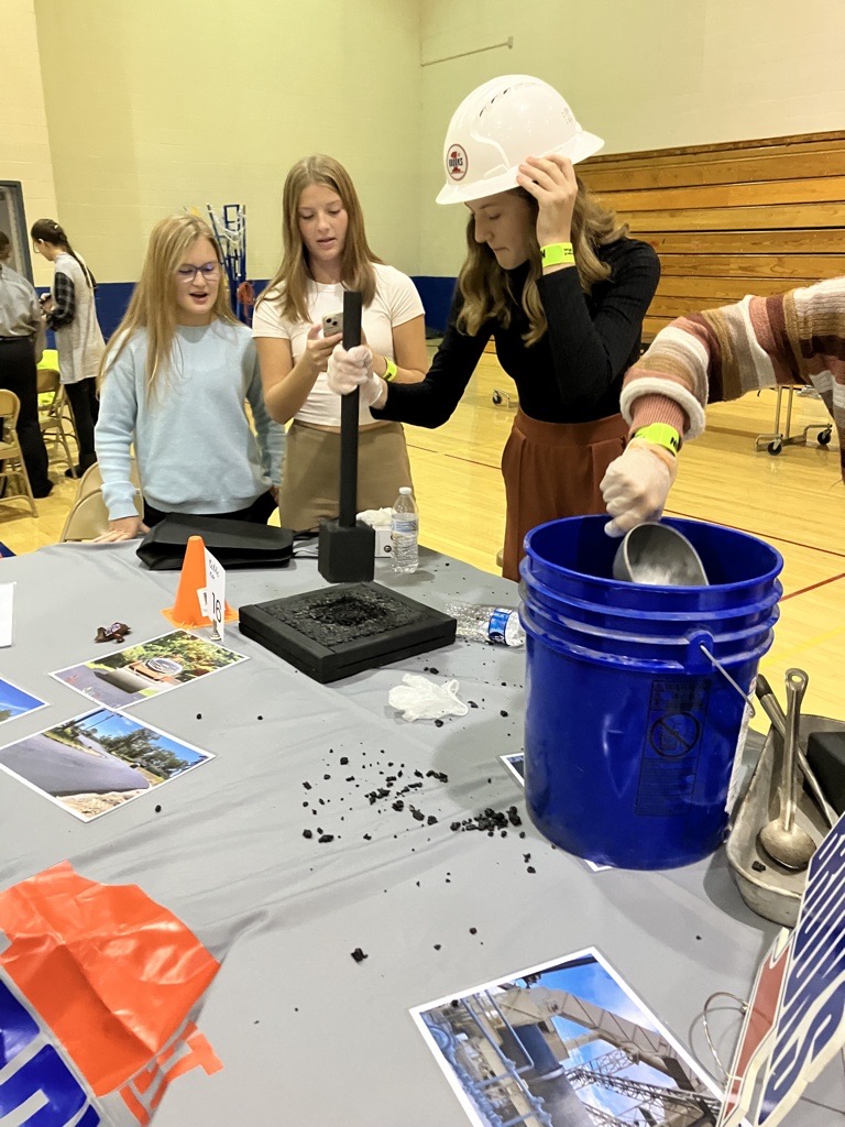 Mentor digging in bucket