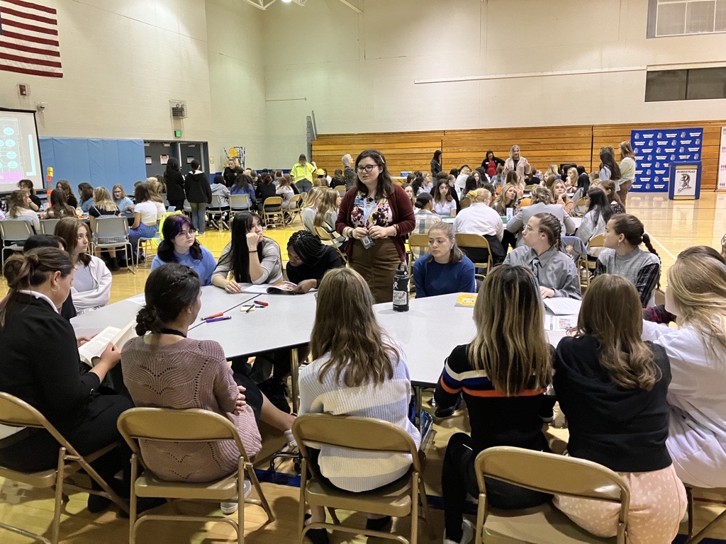 Mentor and students around table