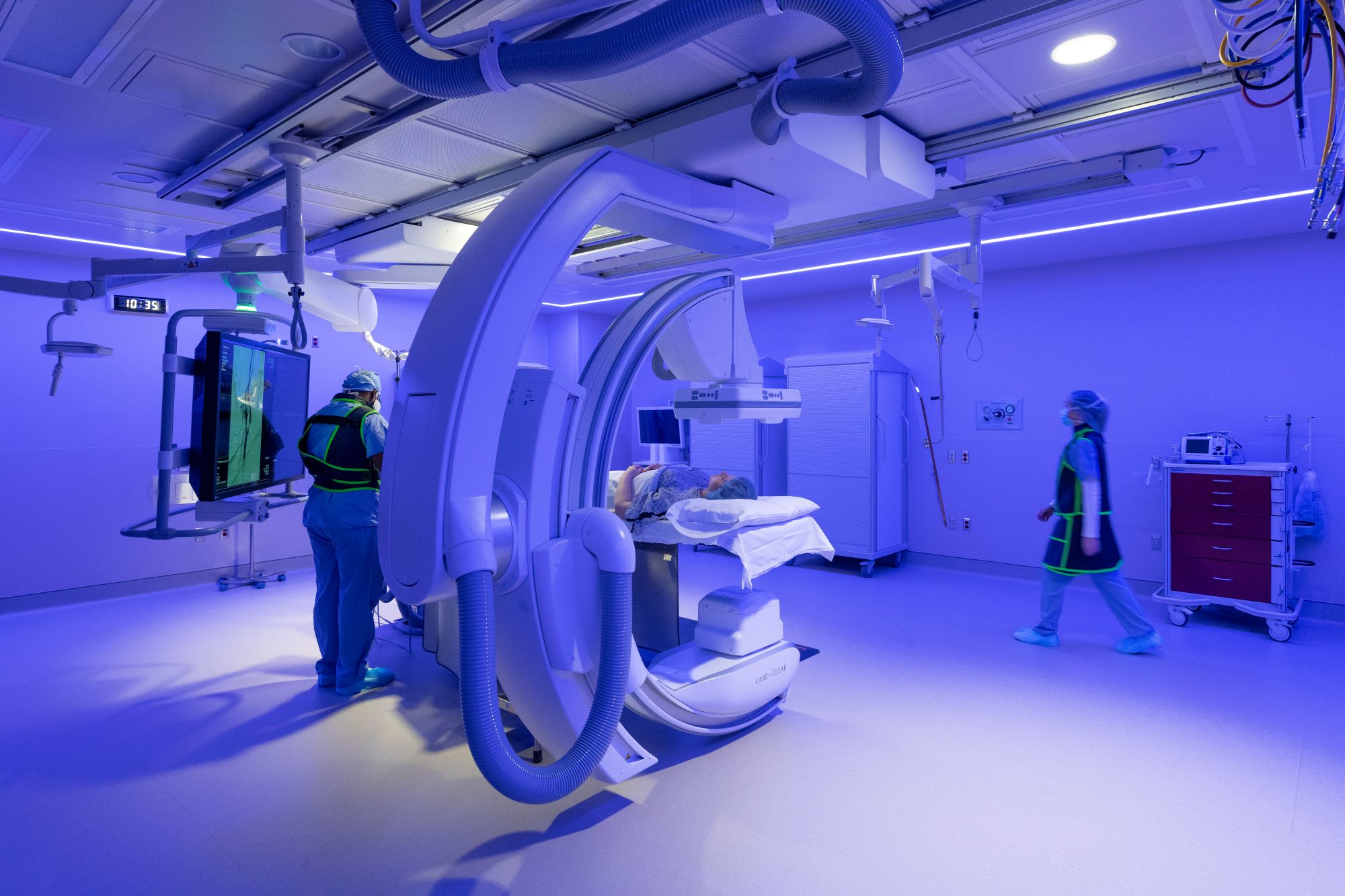 Lutheran Hospital IR Suite purple lights and two nurses with patient on table