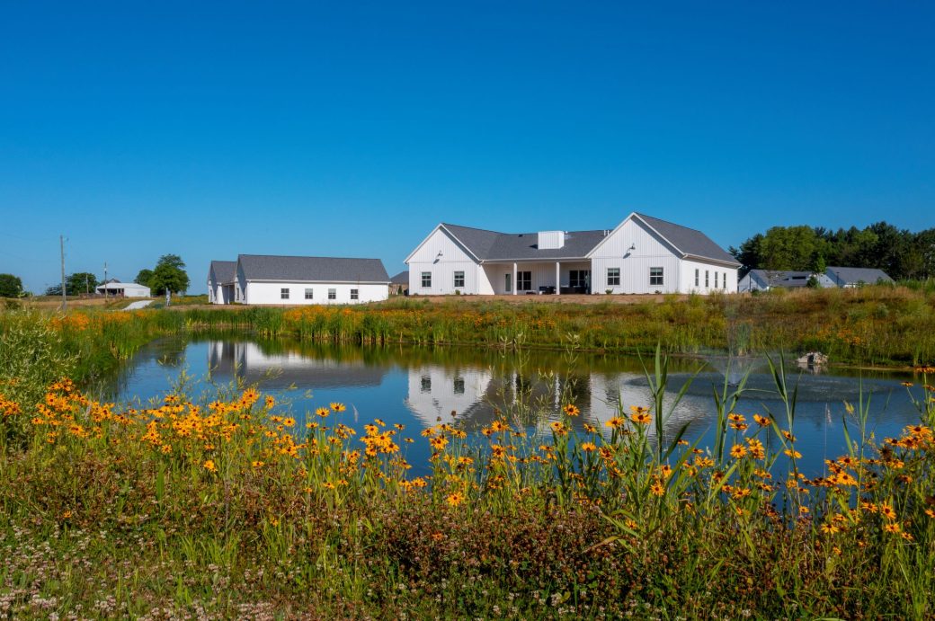 Compass Rose Academy Exterior with Pond