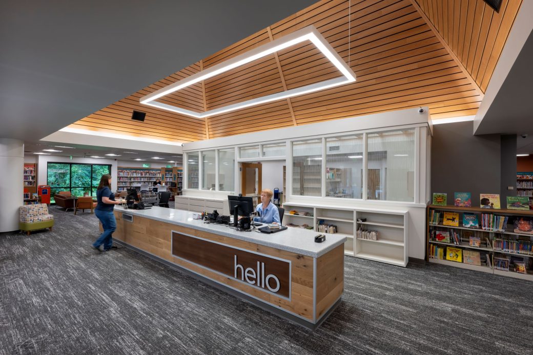 circulation desk under vaulted wood ceiling
