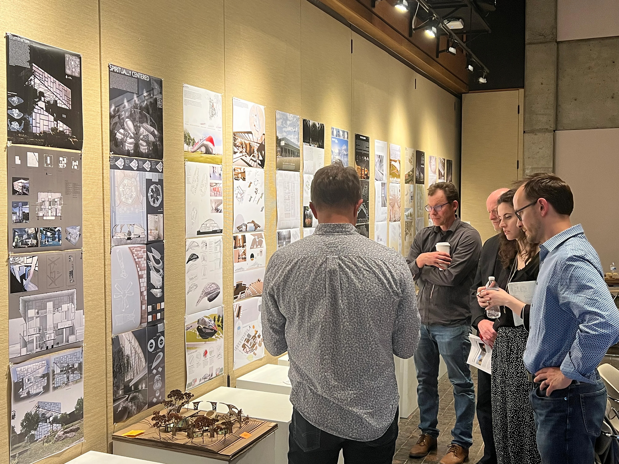 Judges standing around BSU CAP project display