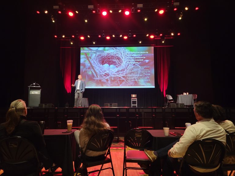 Zach Benedict presentation on a stage at United Front