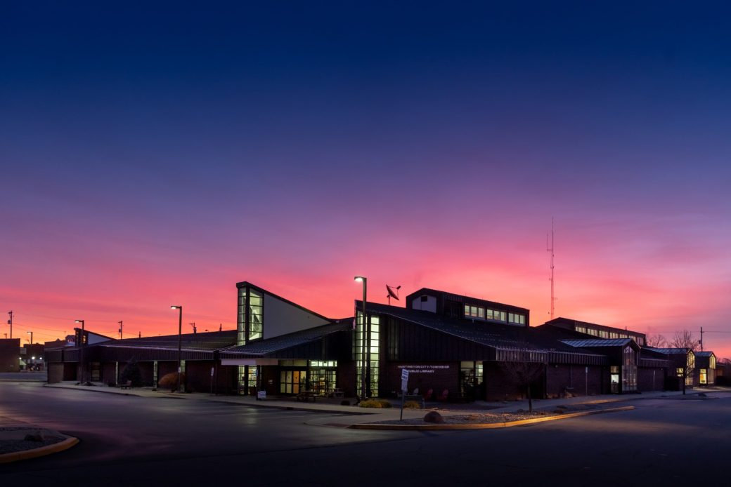 Huntington City-Township Public Library Exterior at dusk pink and purple sky