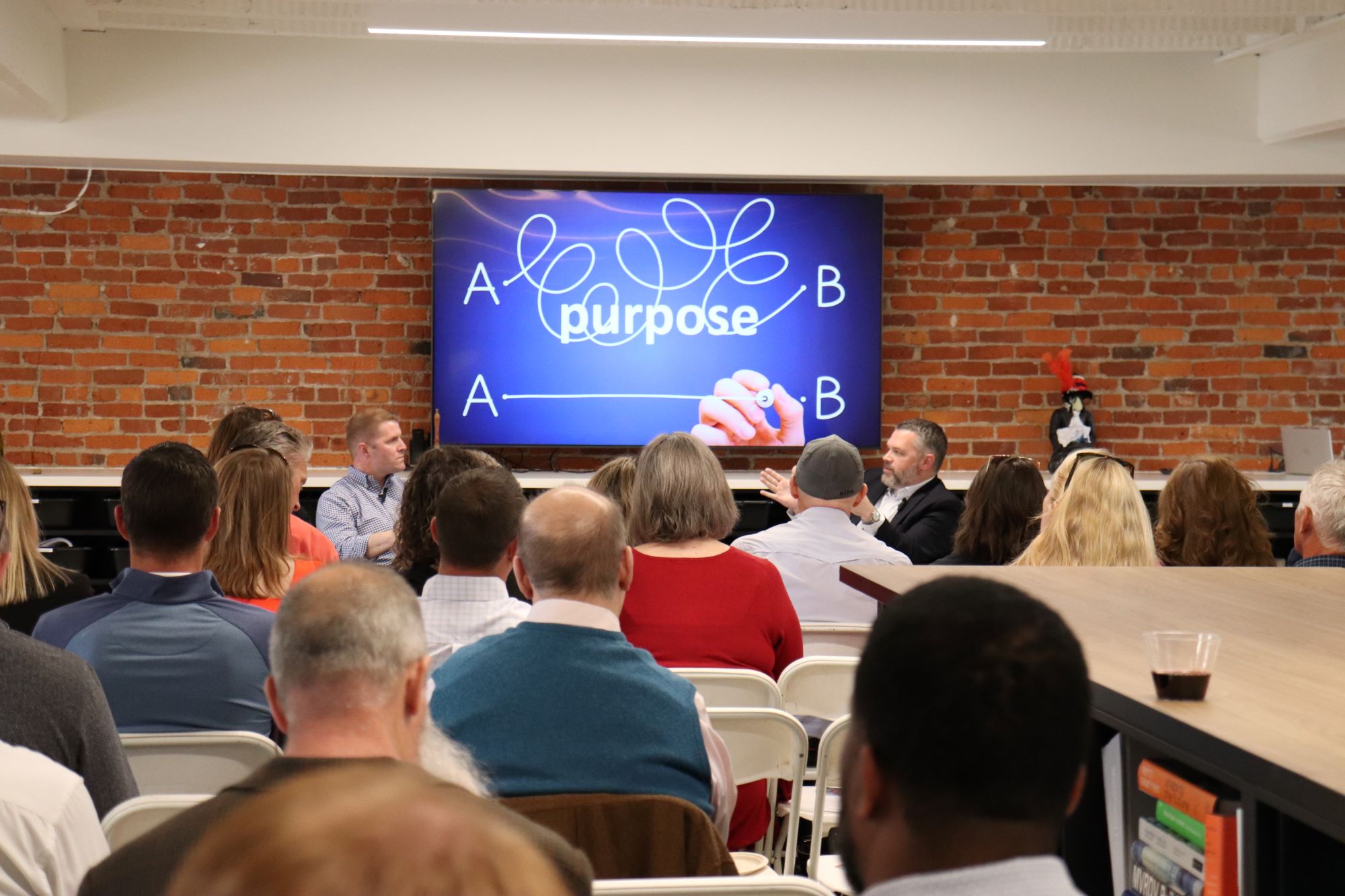 group of attendees listen to Fishbowl event speaker at MKM