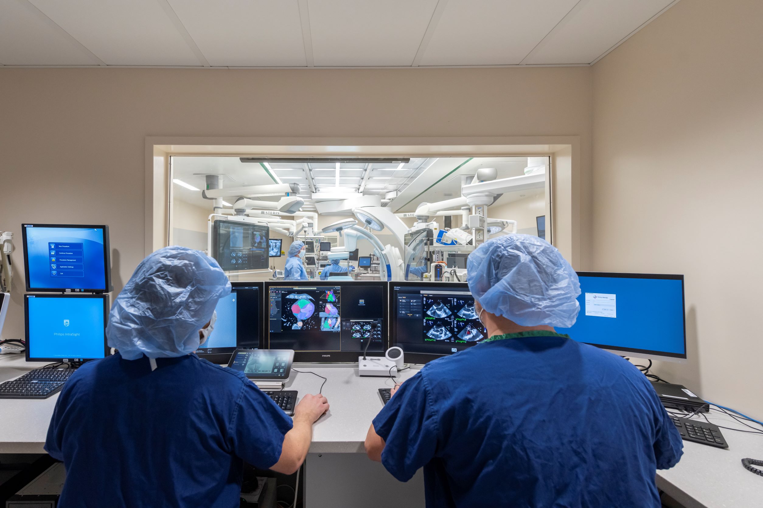 OR Control Room with two people looking through window