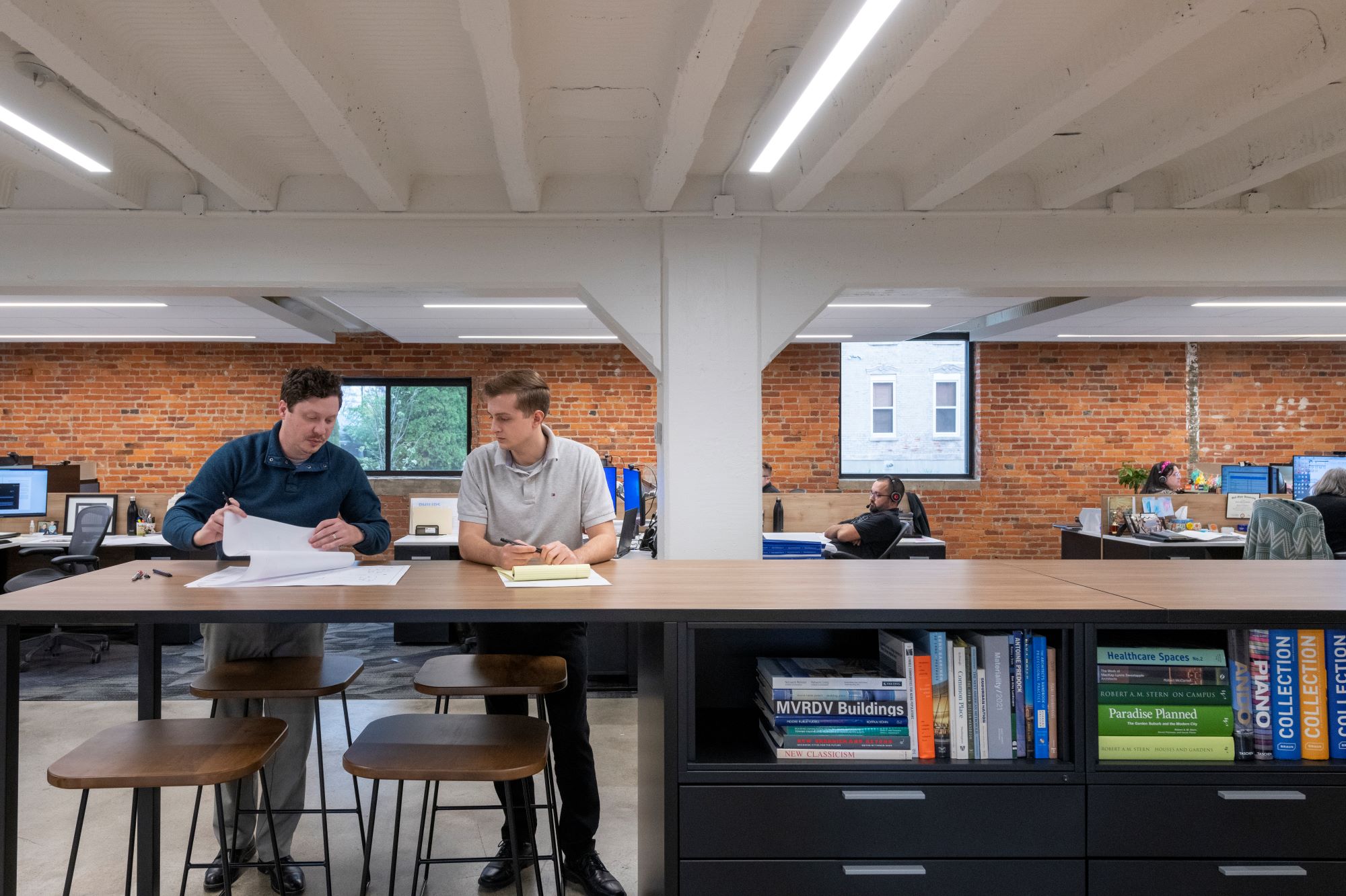 two people collaborating at a large table