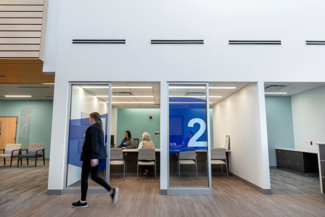 person walking past check-in booth Mercer Health Marion