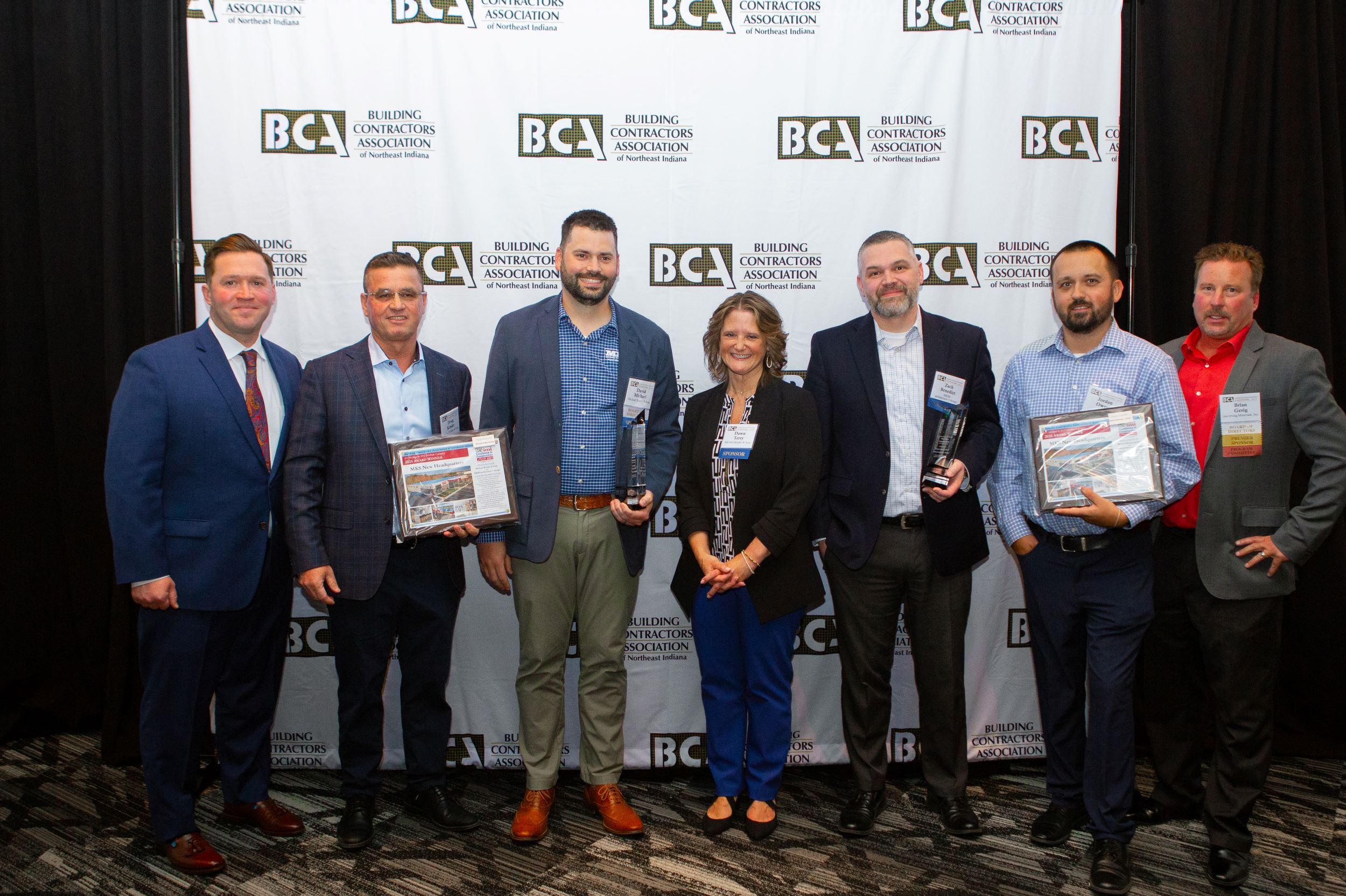 group of people representing Michael Kinder and Sons holding awards