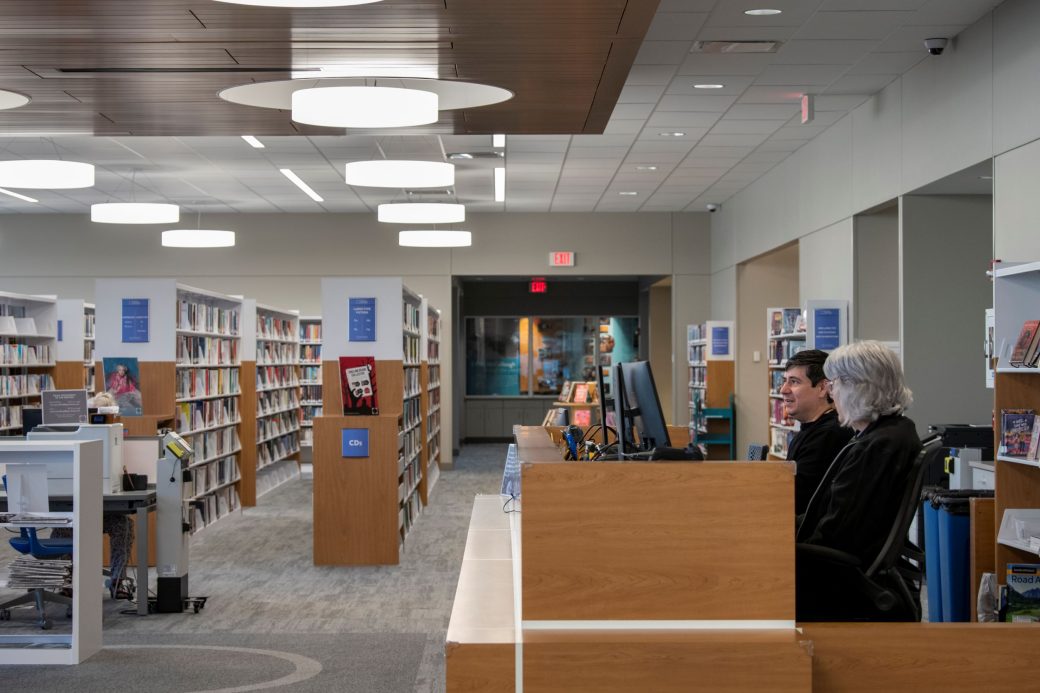 two people at library circulation desk