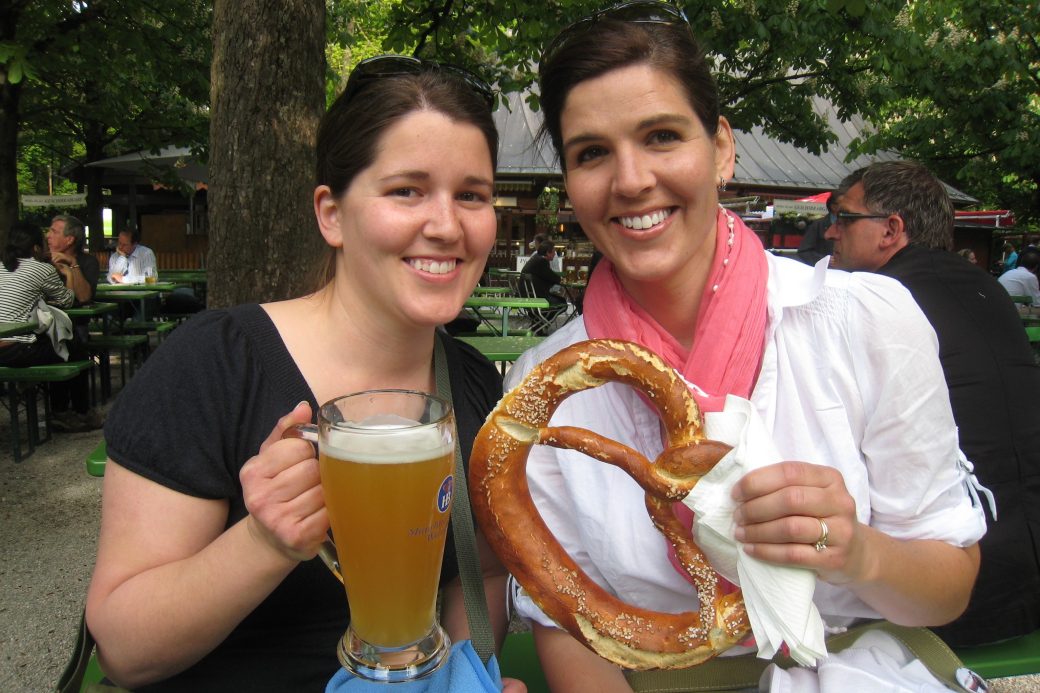 two women with giant pretzel and beer