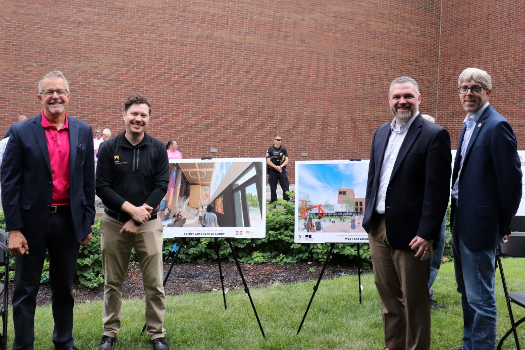 men standing in front of rendering boards