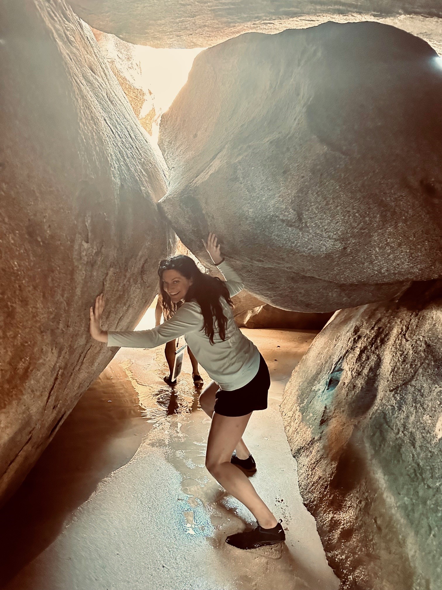 woman walking through cave