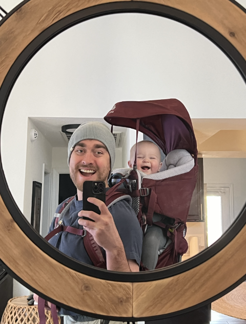 man with son in back carrier