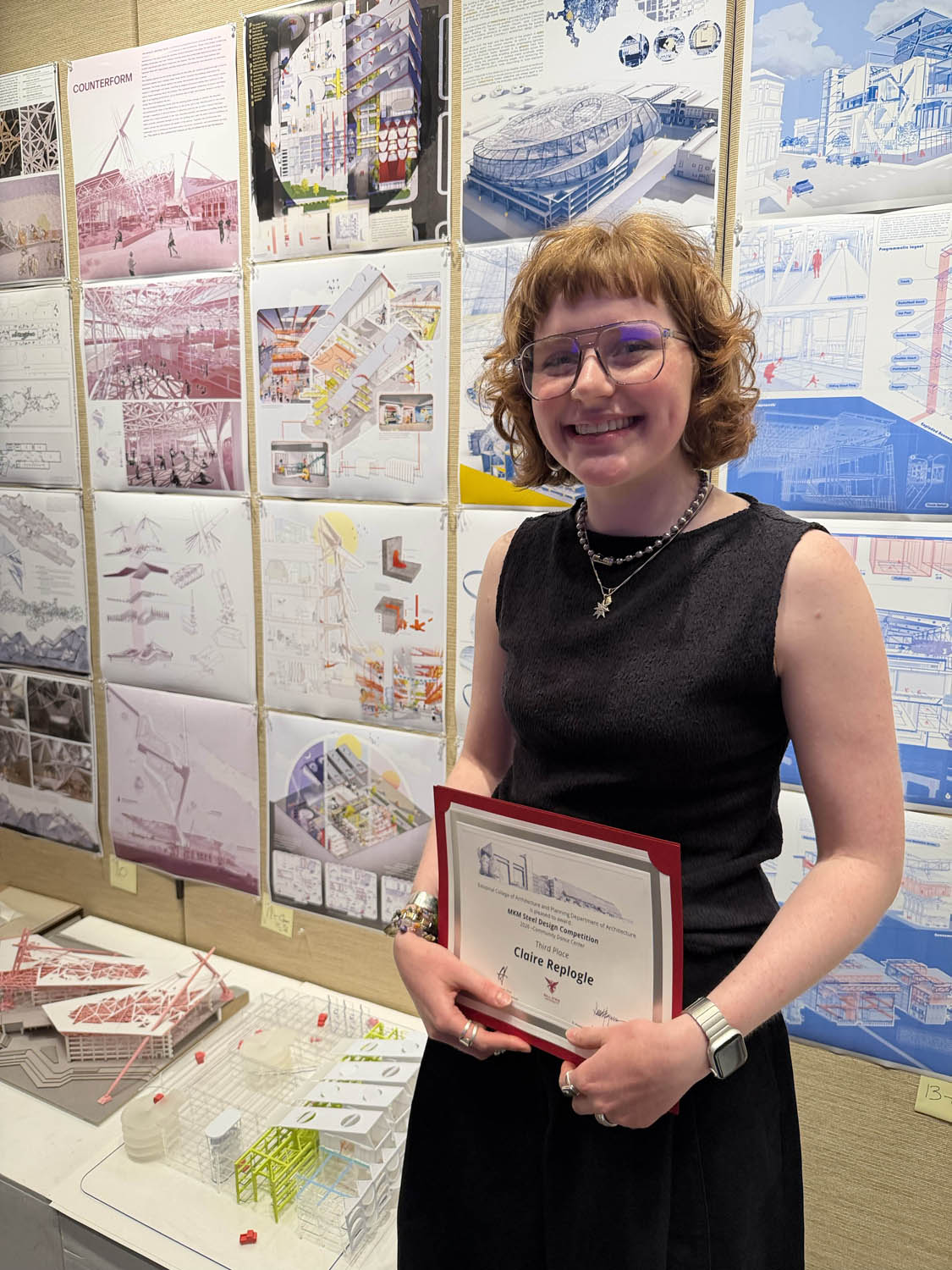 Claire Replogle holding third place certificate at MKM Steel Competition