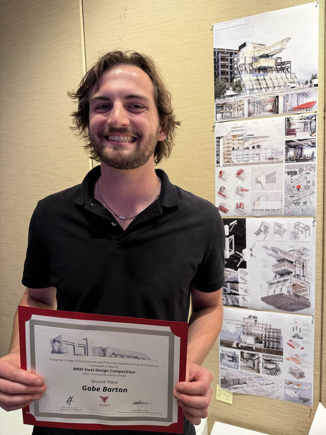 Gabe Barton holding second place certificate at MKM Steel Competition